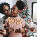 Mother and daughter hold number 2025 new year