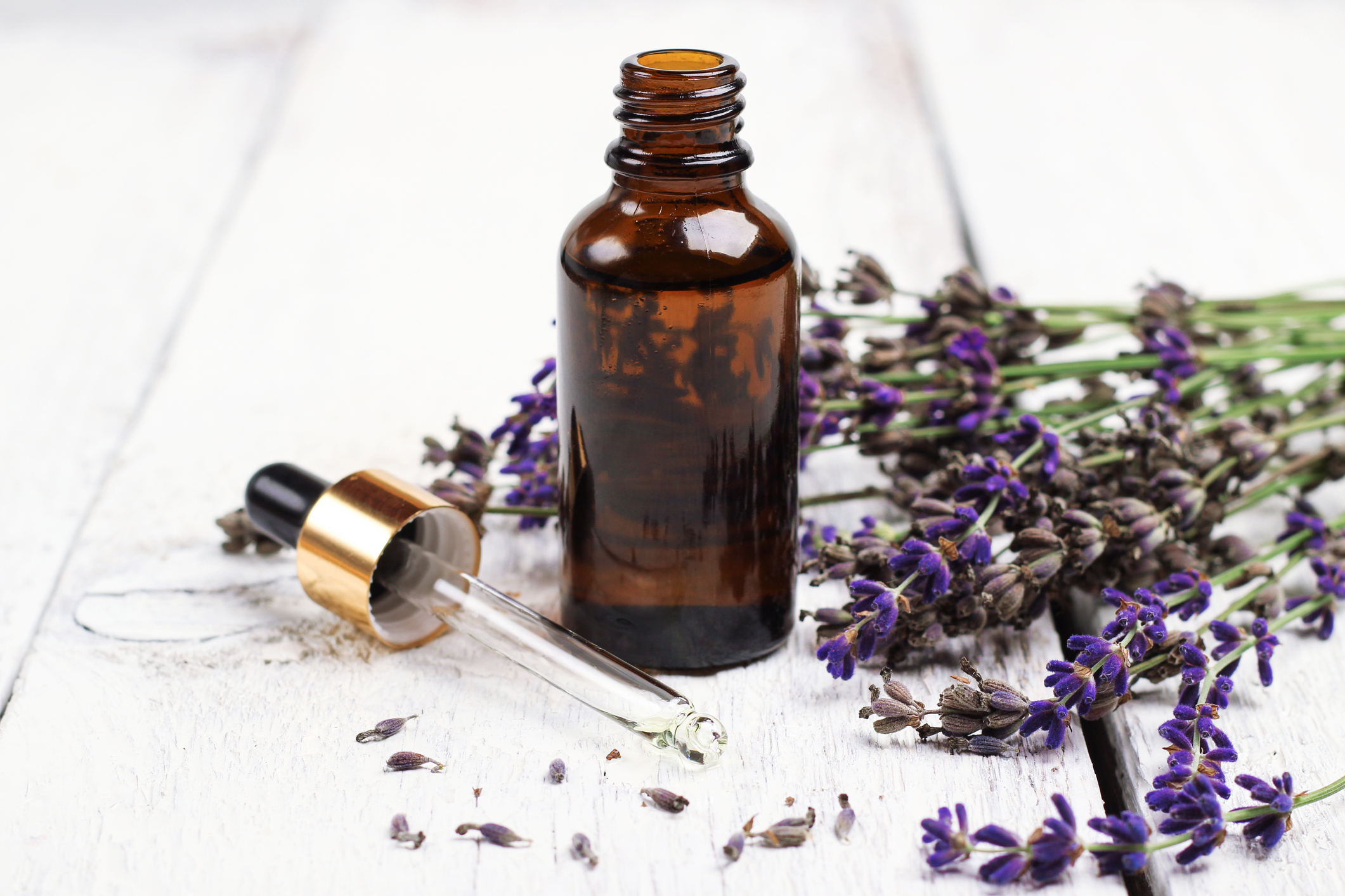 Dry lavender and oil  on a white wooden table