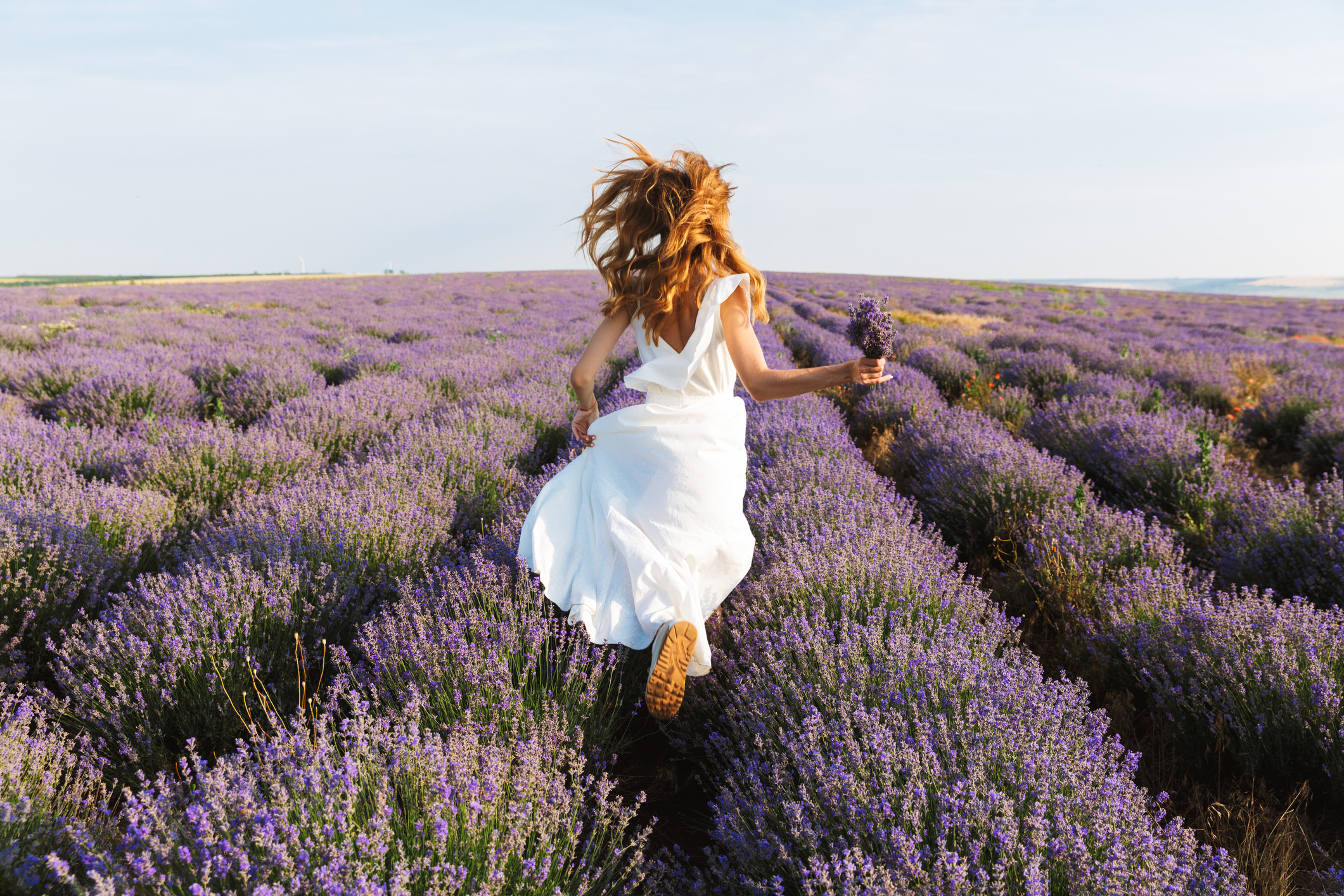 Back view of a pretty young girl in dress running