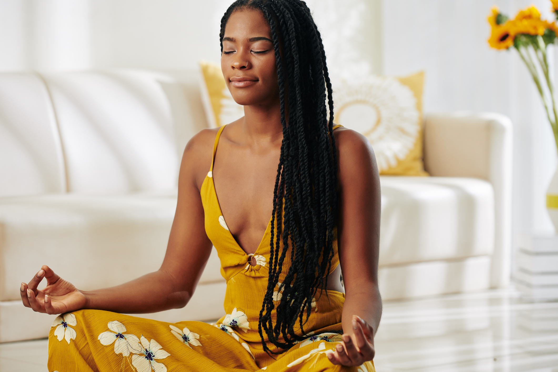 Pretty woman meditating at home