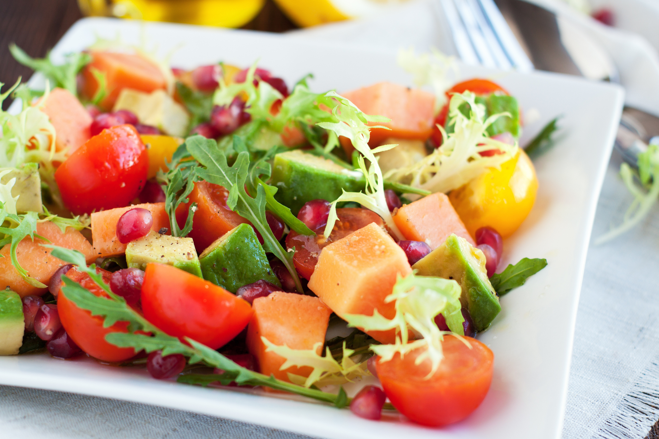 Healthy salad with papaya, avocado, tomatoes