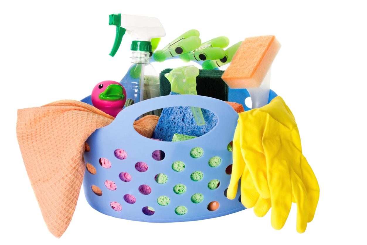 cleaning caddy filled with supplies on white background