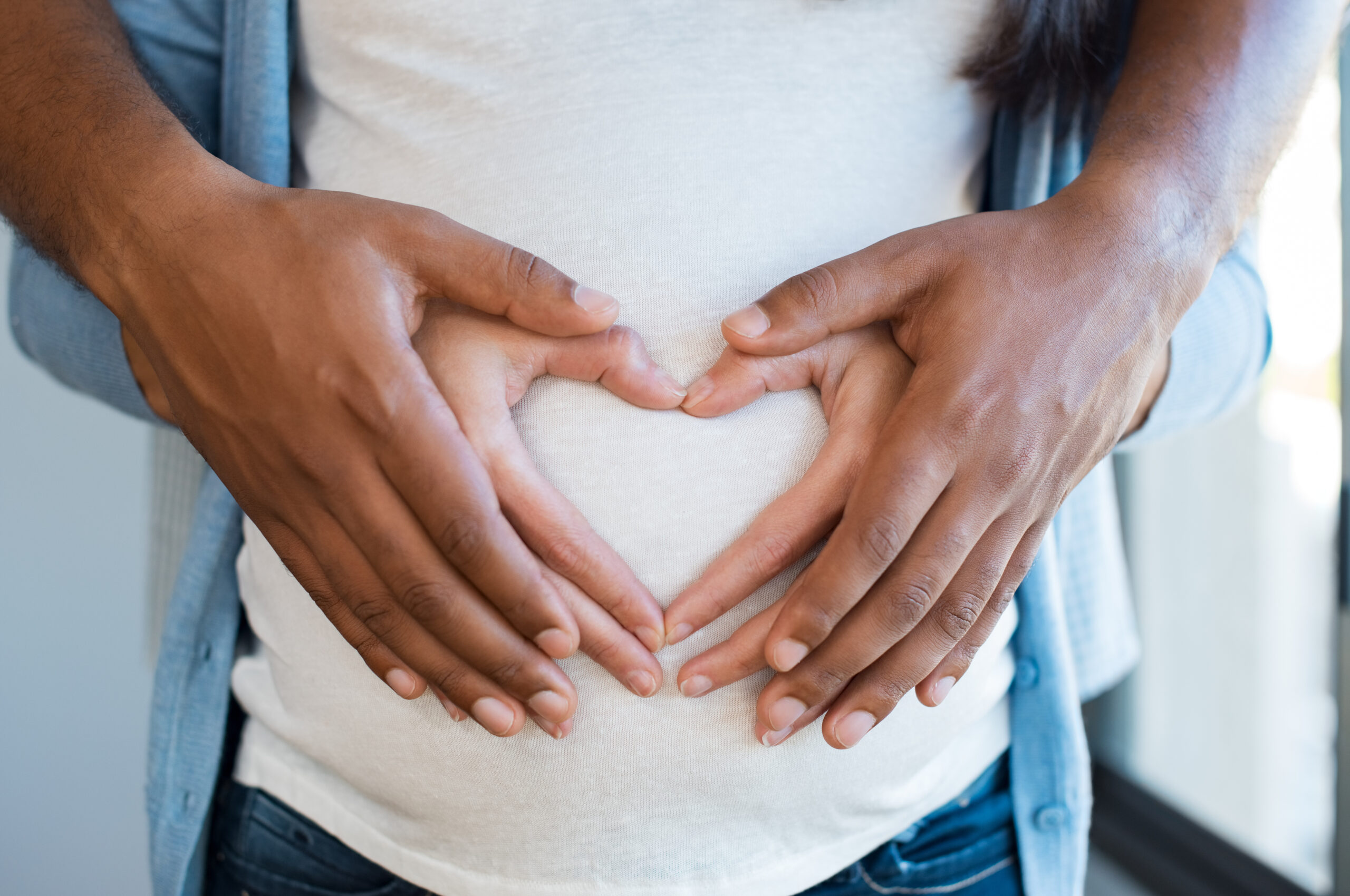 Couple hands on pregnant belly