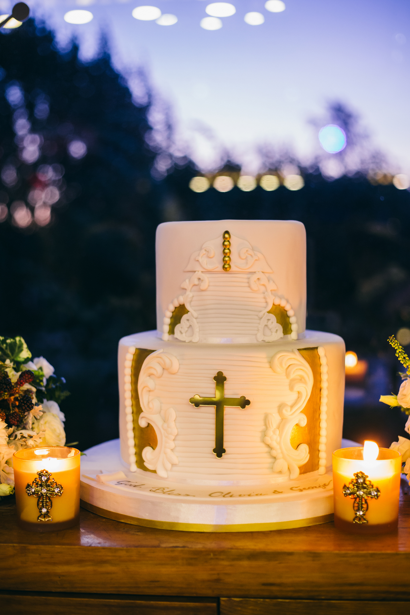 Christening cake in hall with candles on wooden board