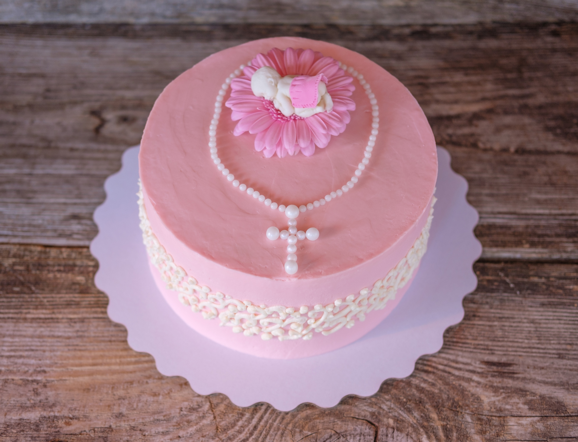 beautiful delicate pink cake with baby figure