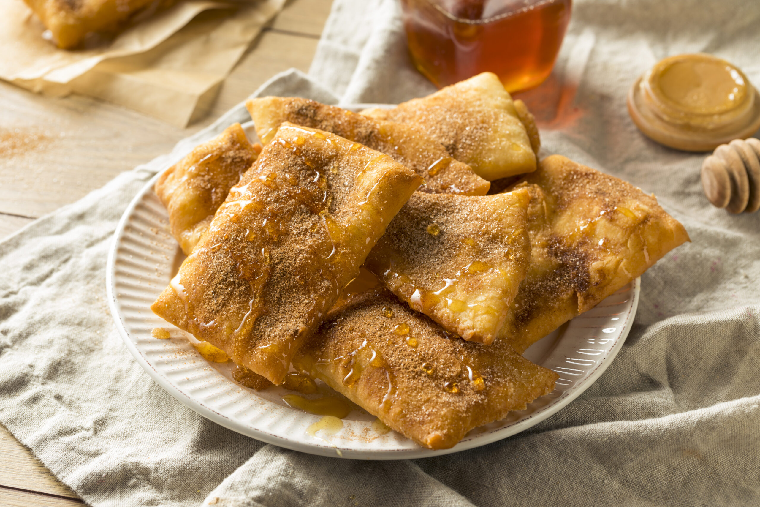 Delicious sopapillas with honey on a plate