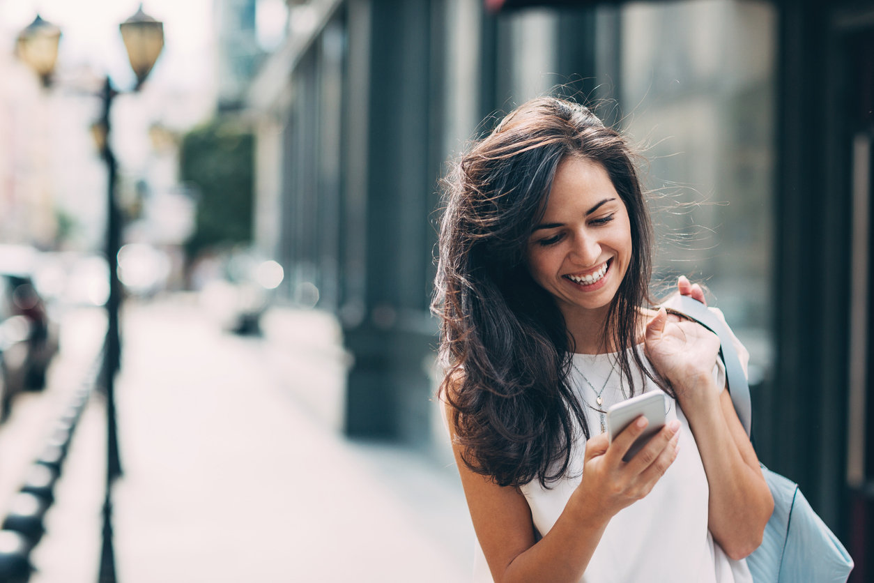 woman walking looking phone