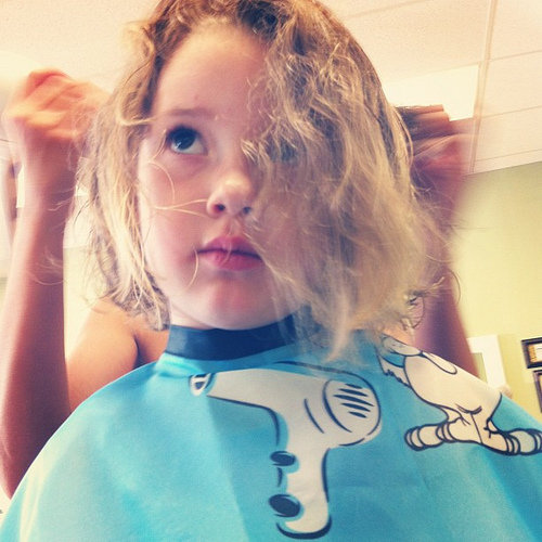 little girl getting hair cut