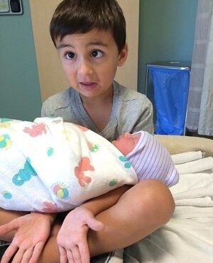 Toddler holding baby sister...Reddit user sho3