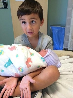 Toddler holding baby sister...Reddit user sho3