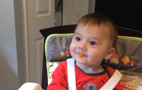 Baby trying solid food for the first time