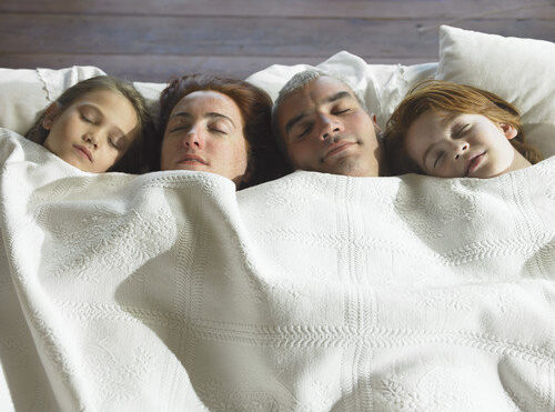 family in bed together