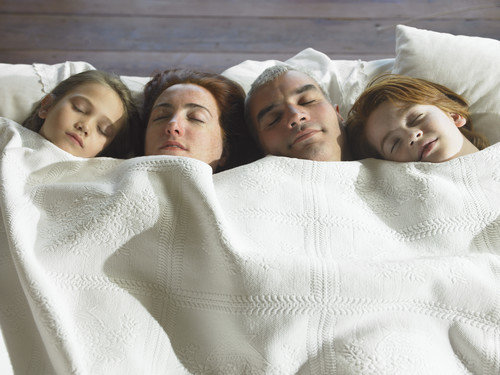 family in bed together