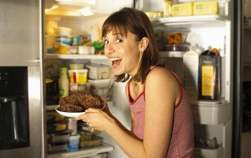 woman looking in refrigerator