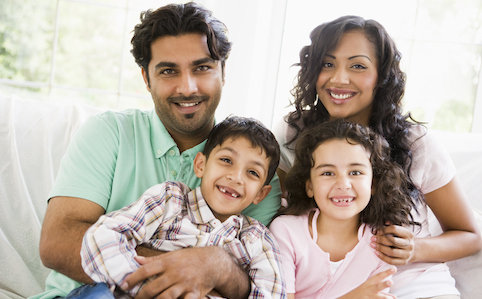 latino family smiling on couch