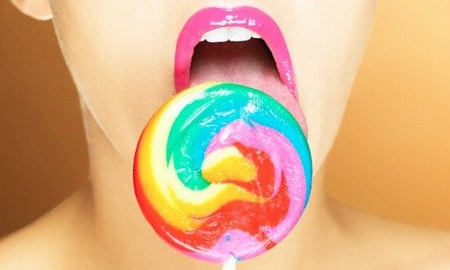 woman licking lollipop