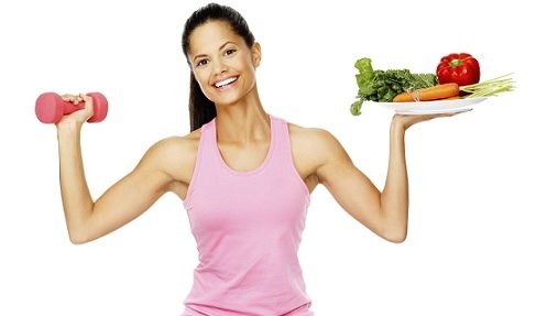 woman holding plate of veggies