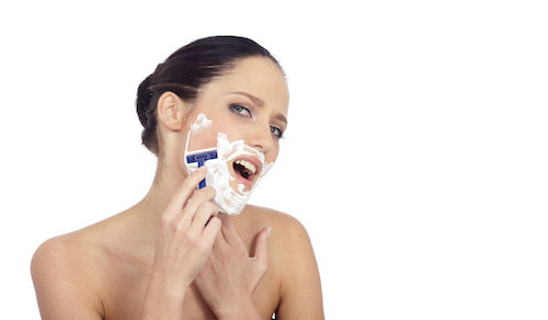 Woman shaving face