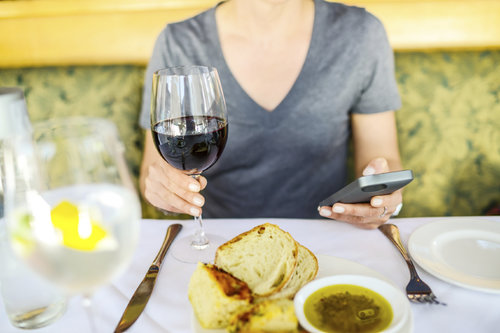 woman taking pic of food