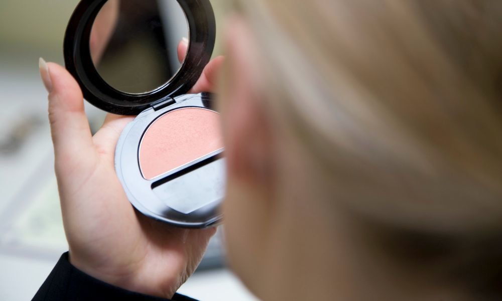 woman looking at mirror