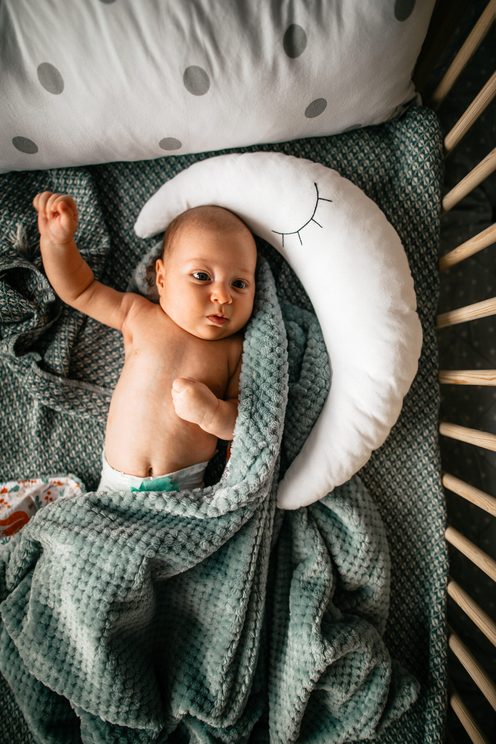 Cute newborn baby lying down in crib