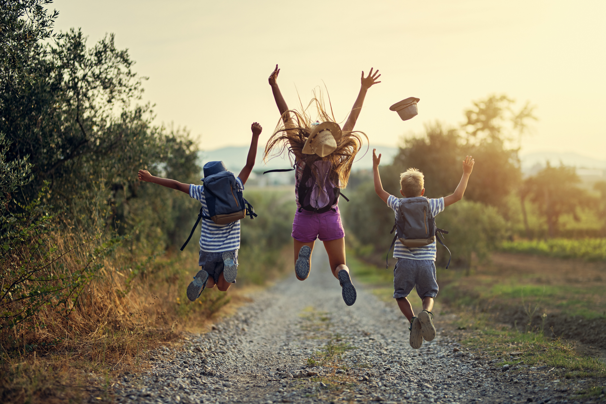 Happy little hikers jumping with joy