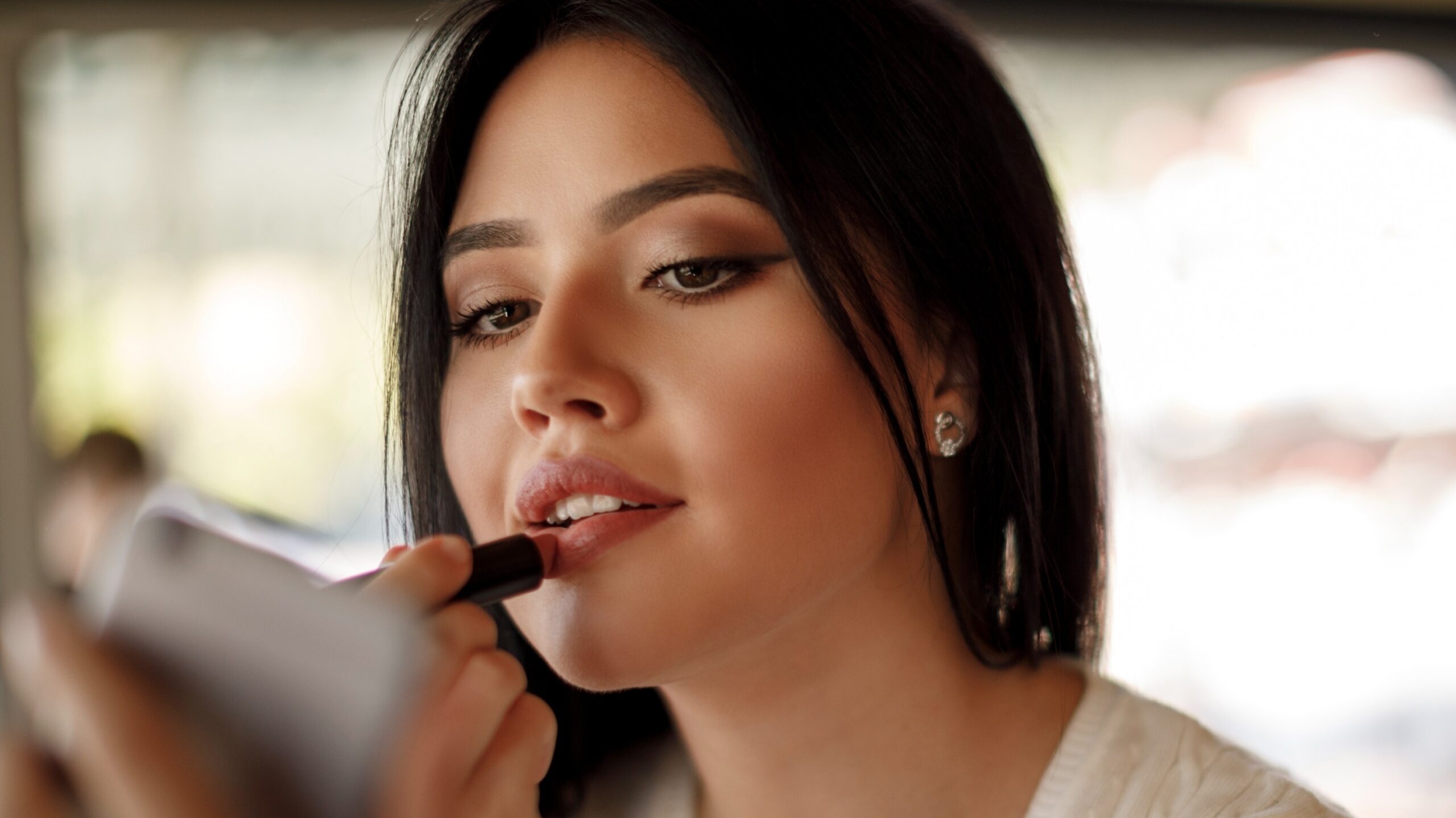 woman applying lipstick