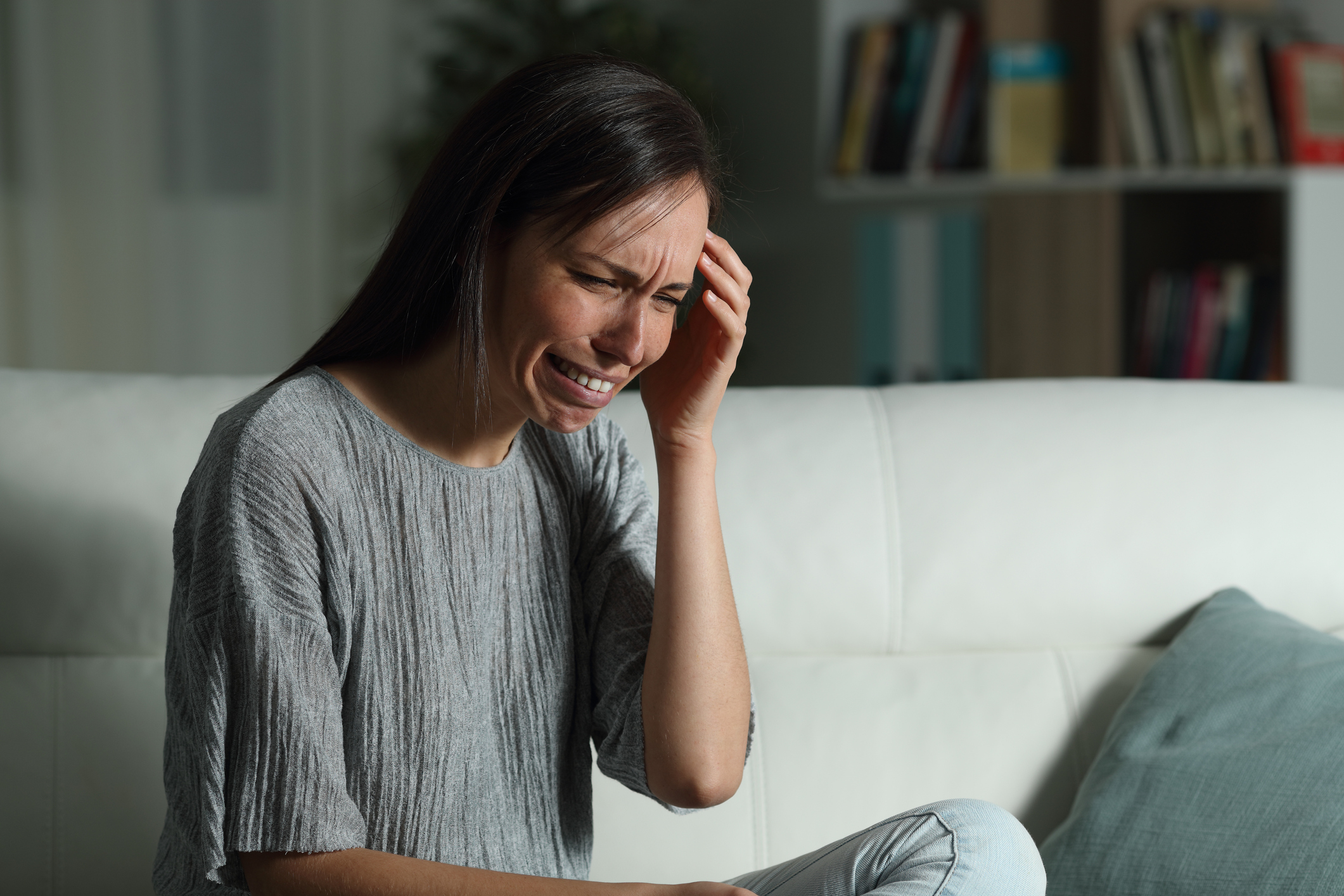 Sad woman complaining at home in the night