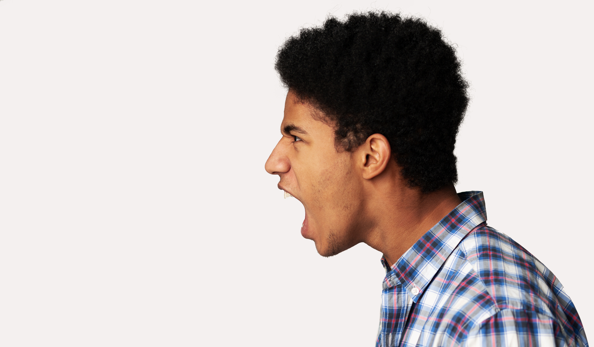 Furious Afro Guy Shouting over Light Background