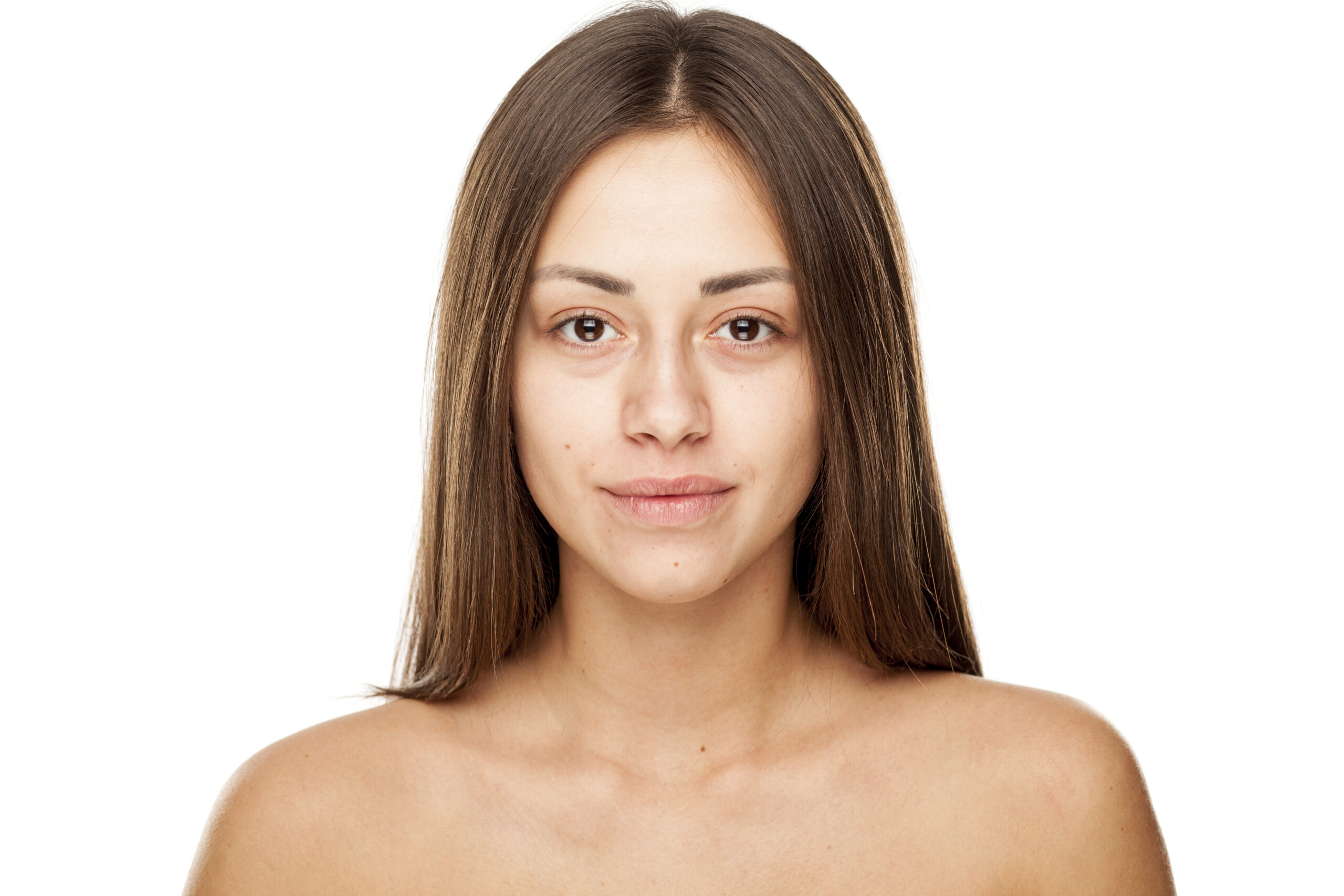 Portrait of young beautiful smiling woman with no makeup on white background