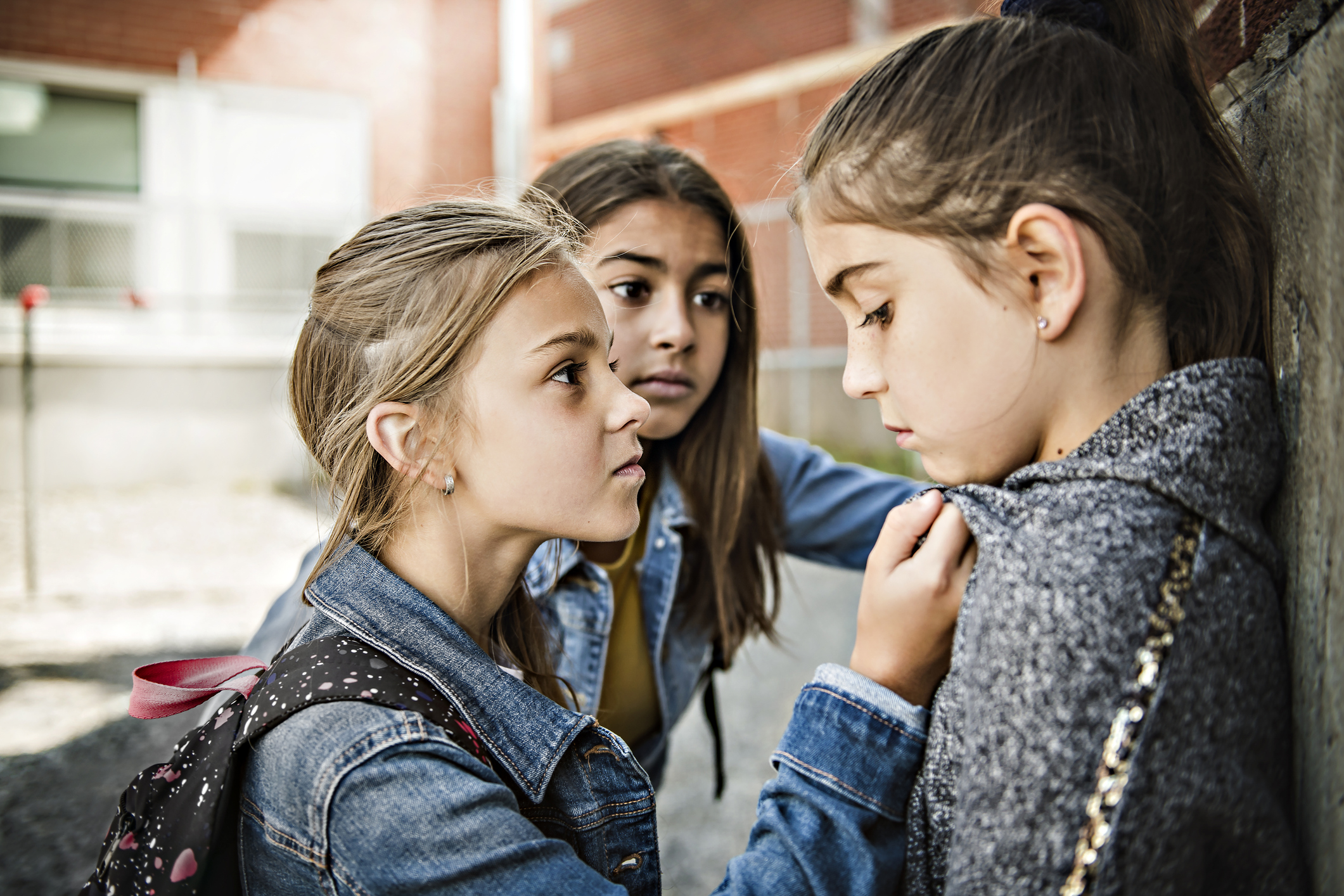 A sad girl intimidation moment on the elementary Age Bullying in Schoolyard