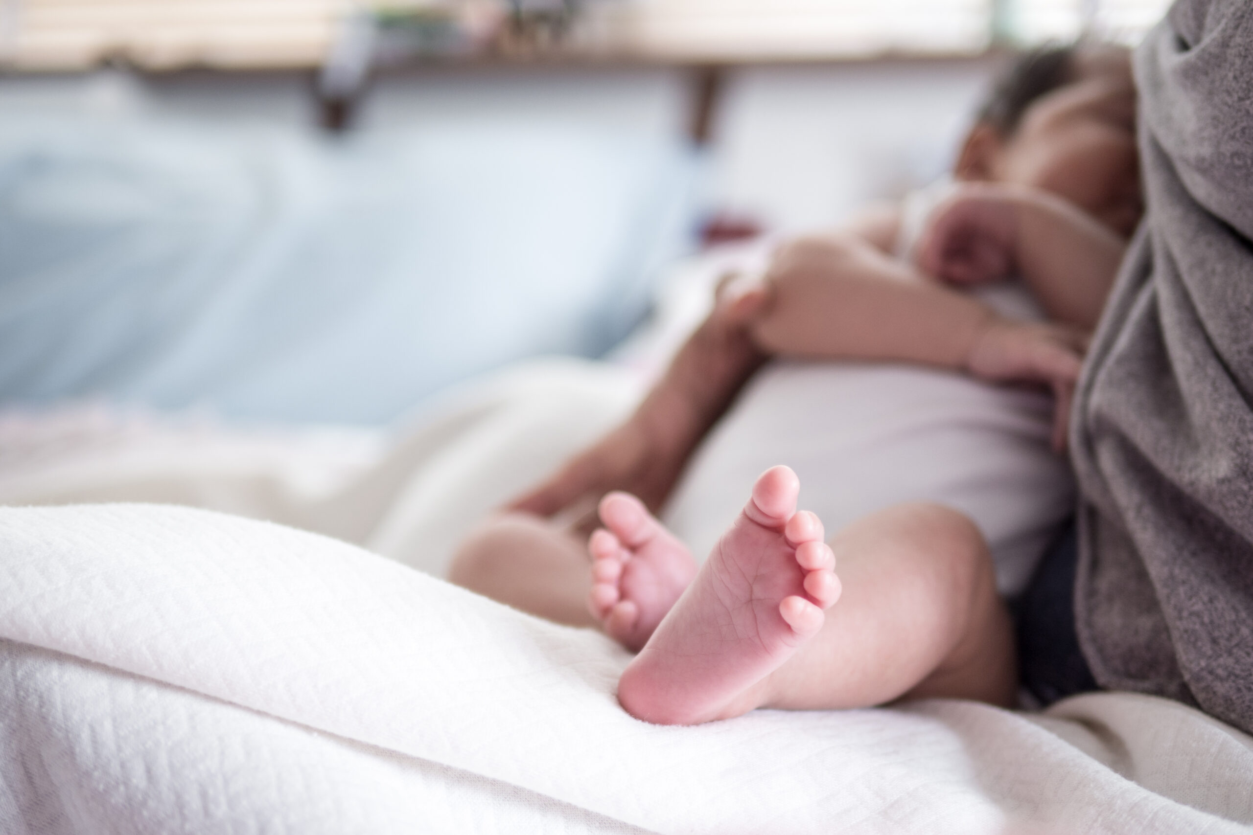 Horizontal , mother feed baby with breast milk.