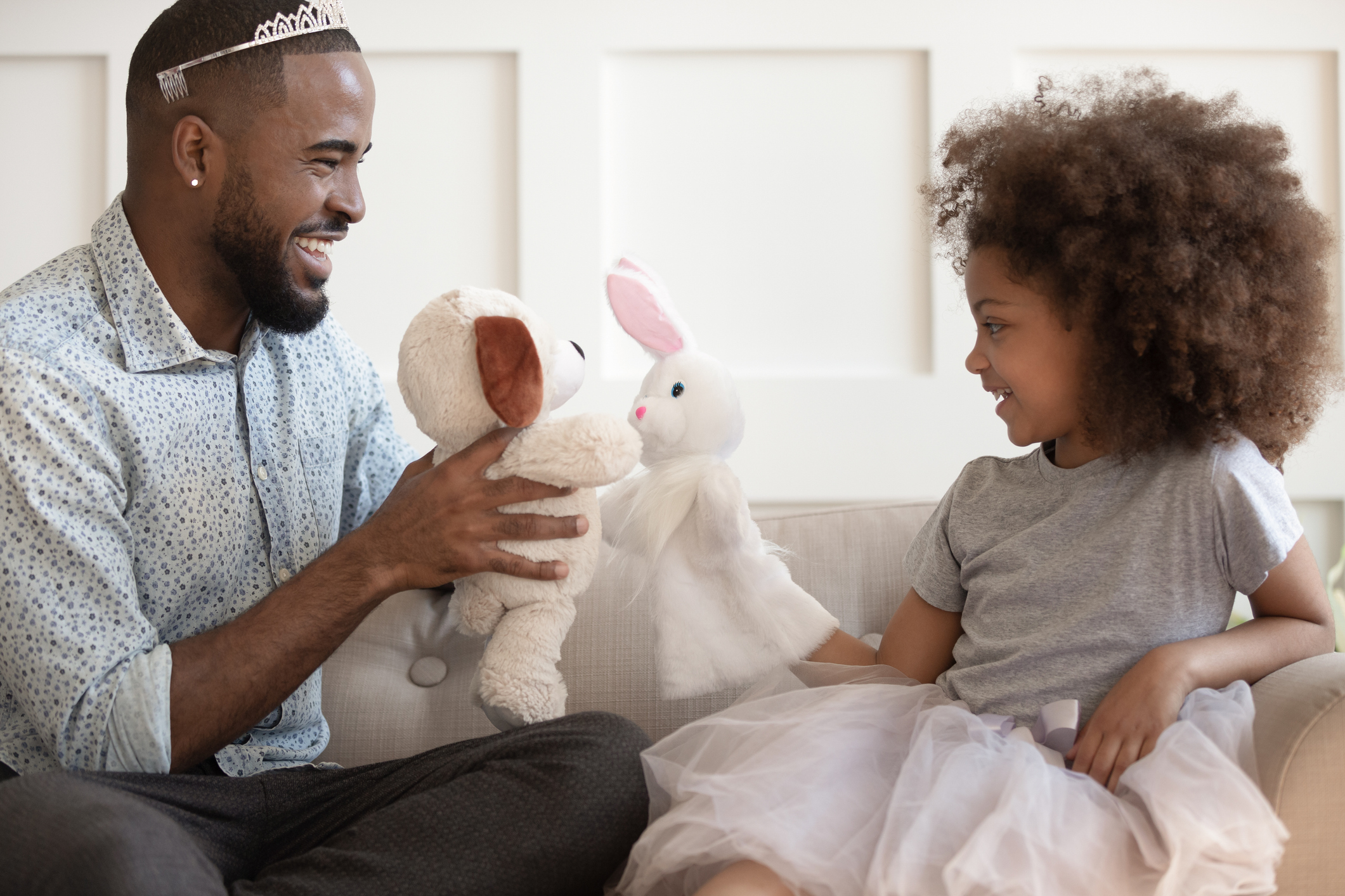 Funny biracial dad have fun playing with little daughter