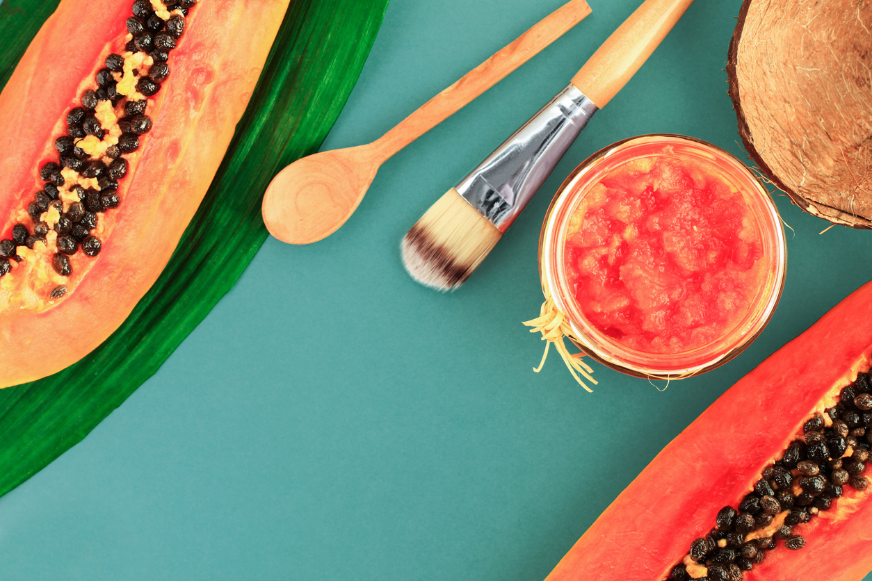 Papaya facial mask, homemade cosmetics beauty skin therapy, fresh juicy orange fruit pieces