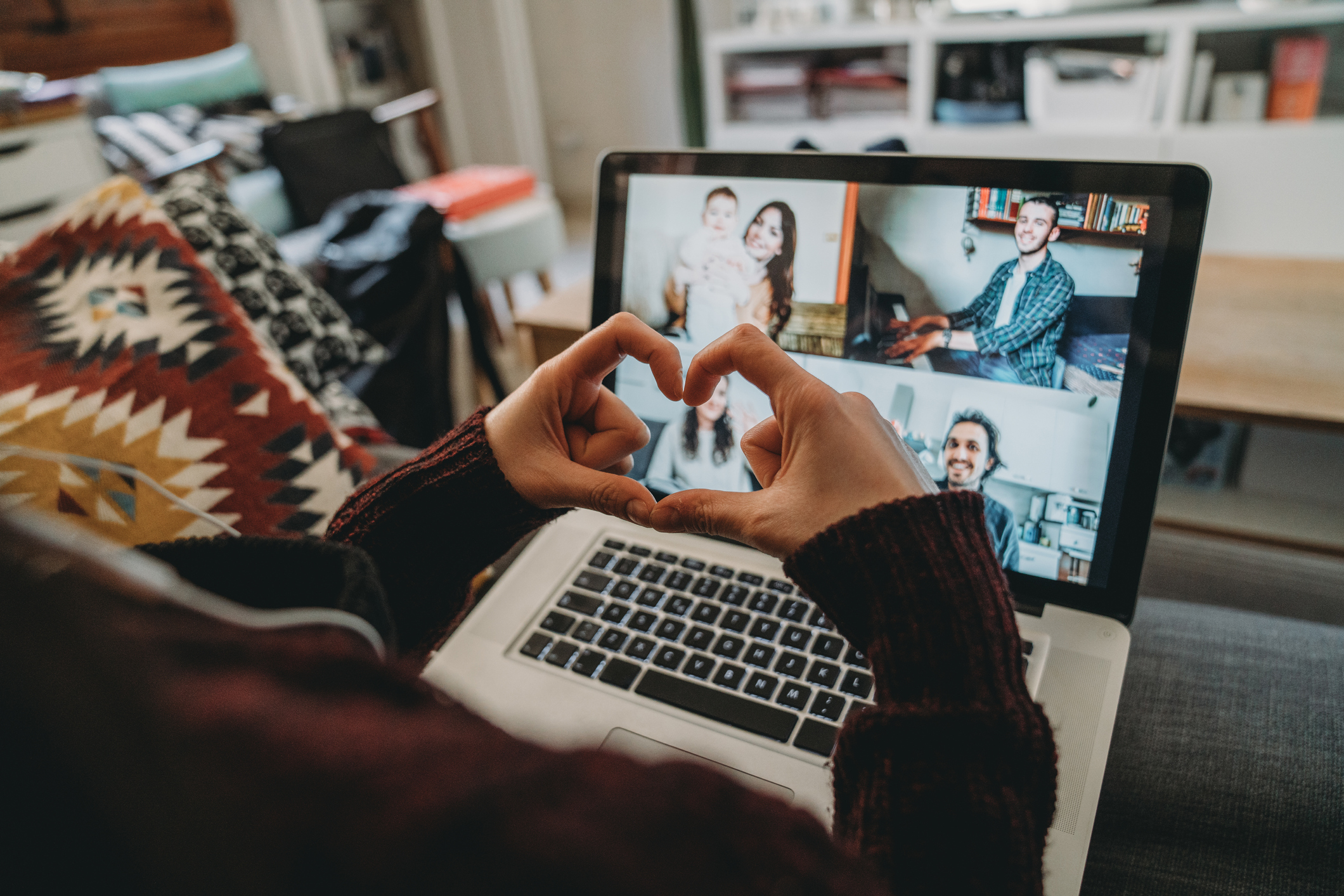 Young woman using a laptop to connect with her friends and parents during quarantine