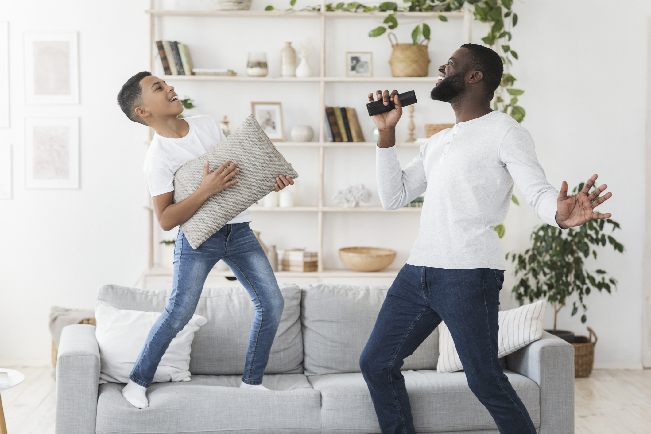 Happy black father and little son having fun together at home