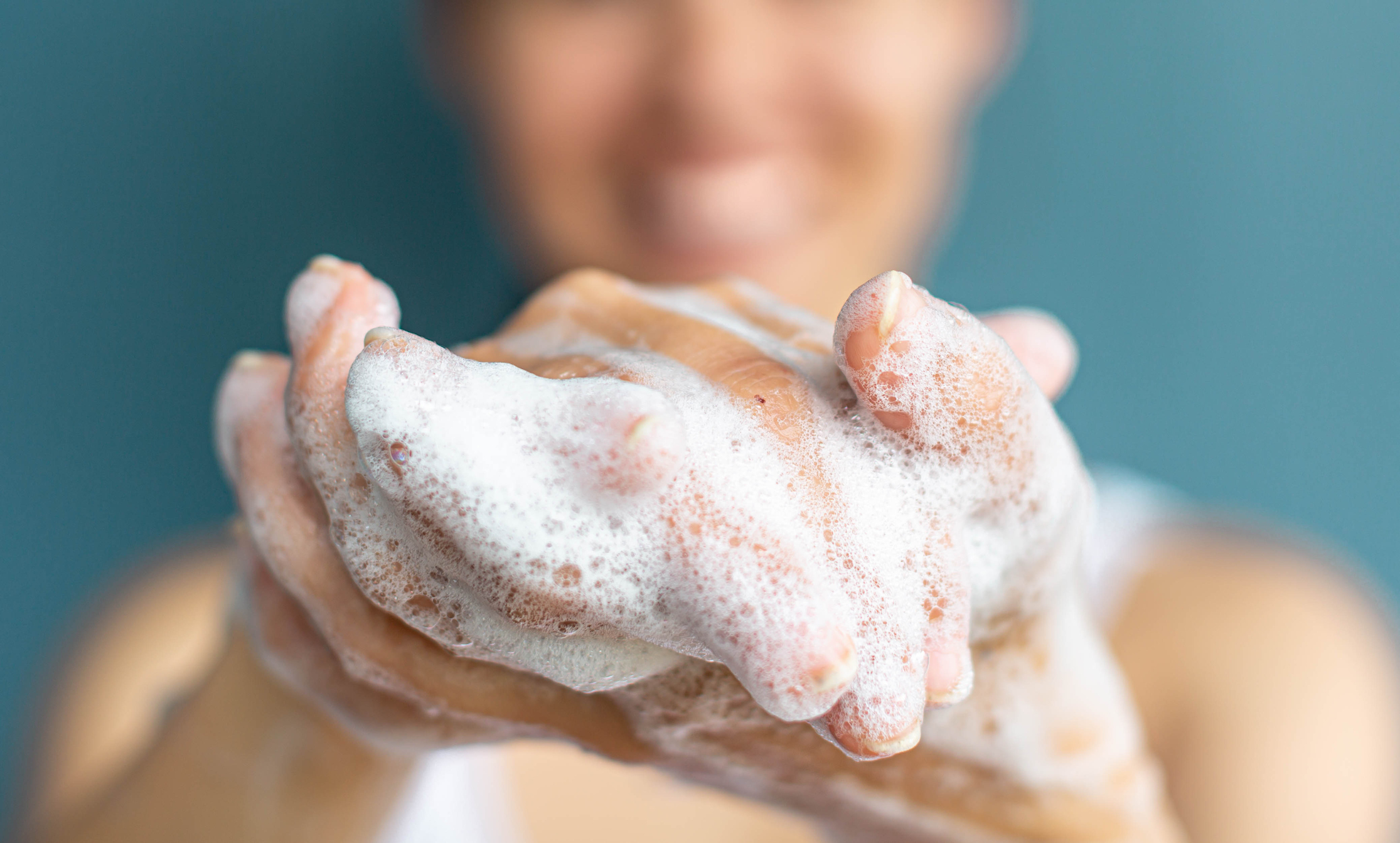 Person  washing their hands with soap and water. Hygiene and cleanliness