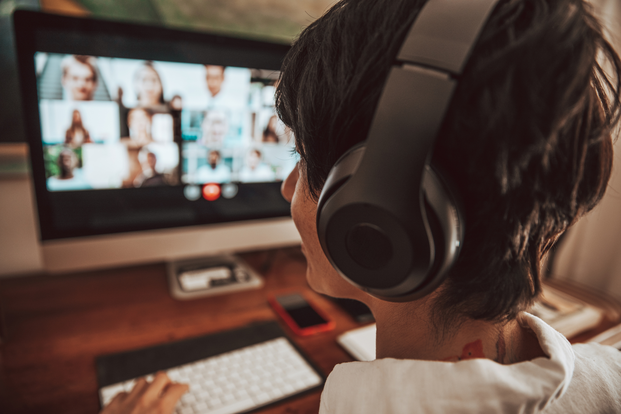 Woman working at home having a video conference with colleagues