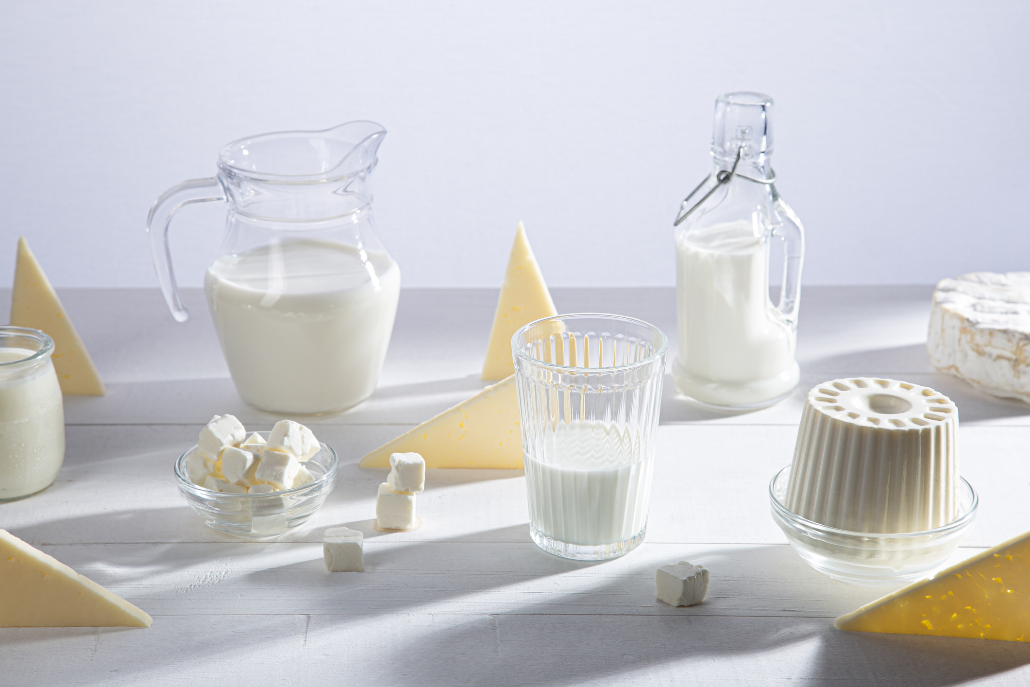 Dairy products in glass recipients on white background.