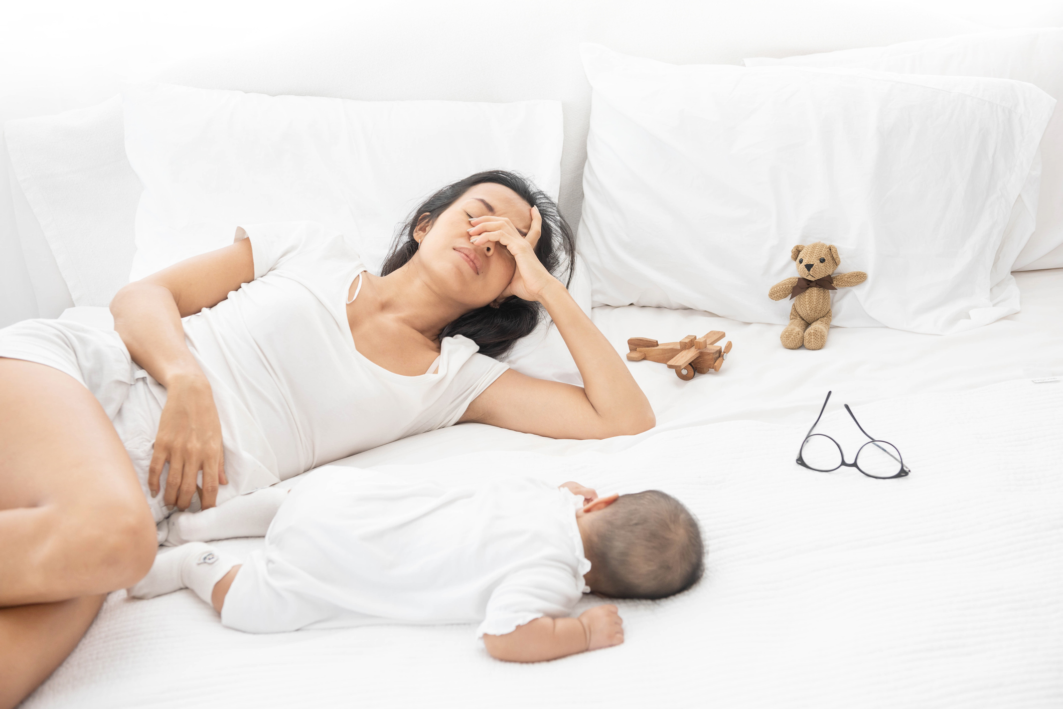 Tired Exhausted Mother Sleeping Sleep With Baby On White Bed