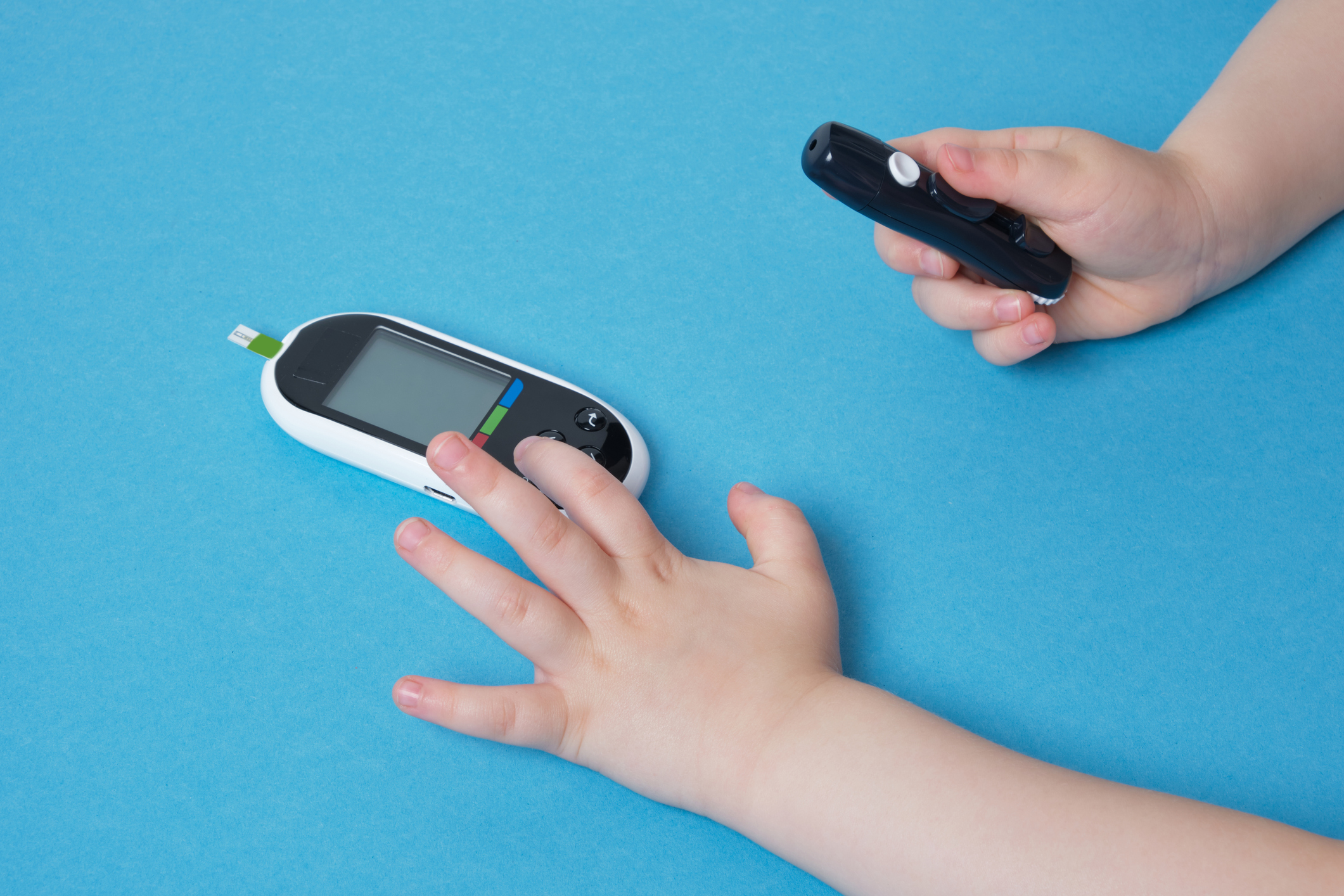 small child presses the button glucose meter, blood glucose meter, childhood diabetes, child health care