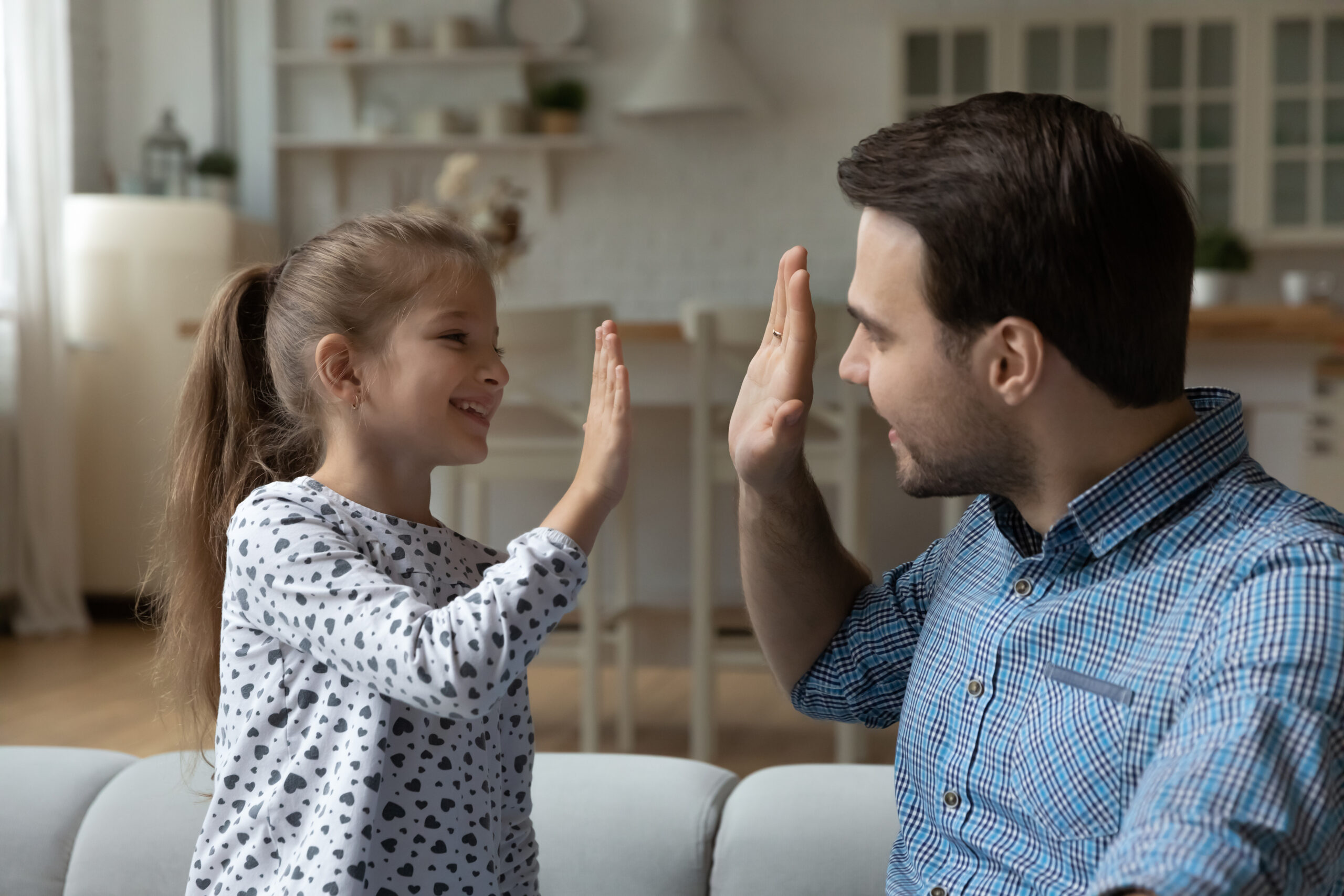 Happy proud dad and daughter giving high five