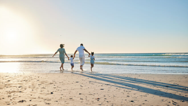 iStock-1397843969 family on a beach