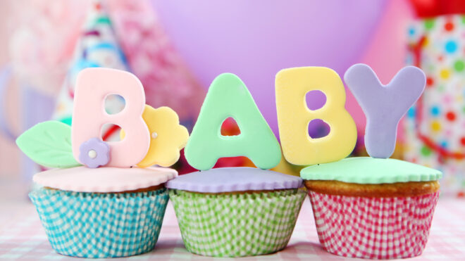 cupcakes de colores con letras encima que dicen baby