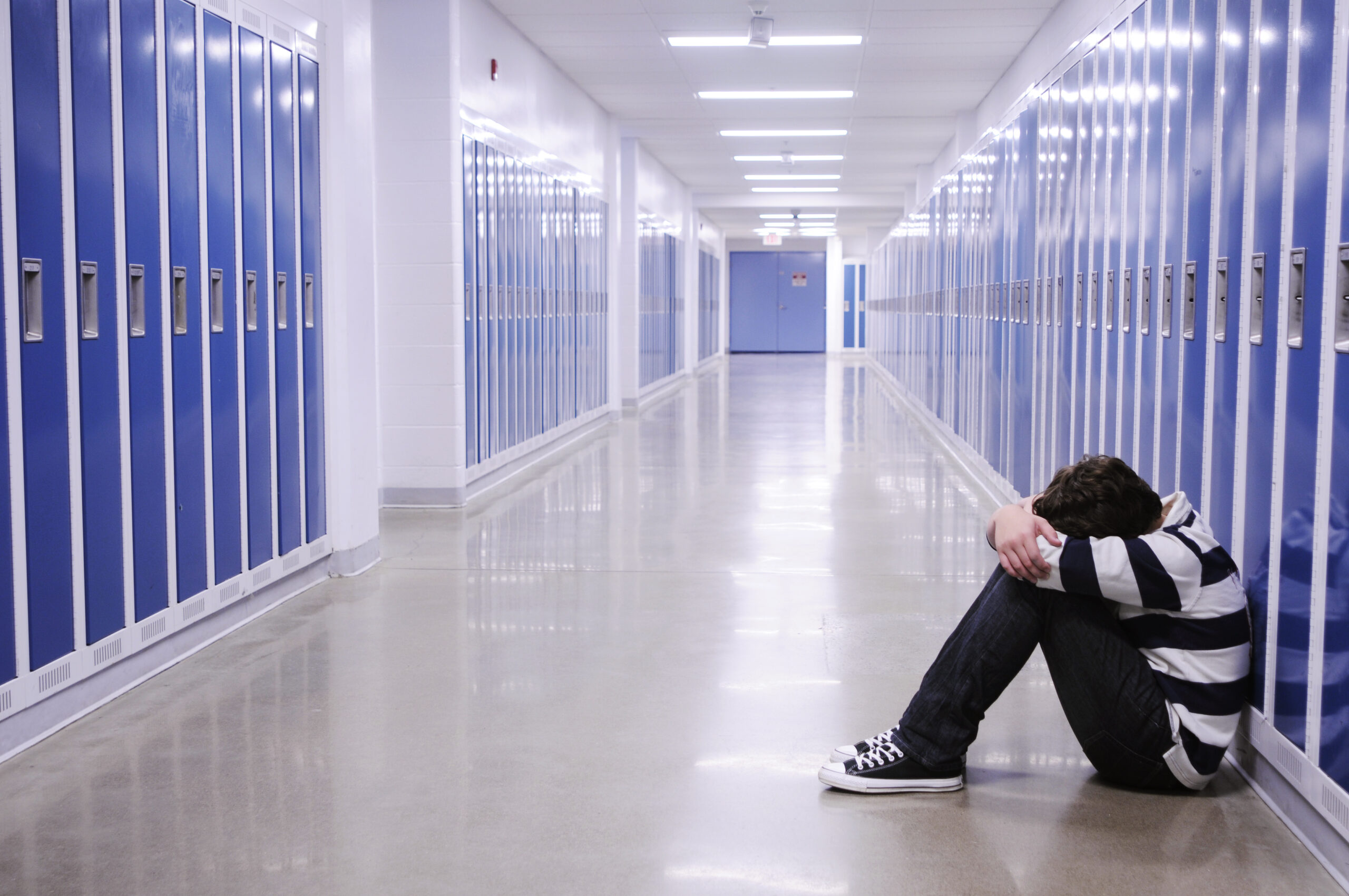 Depressed Boy in School Hallway