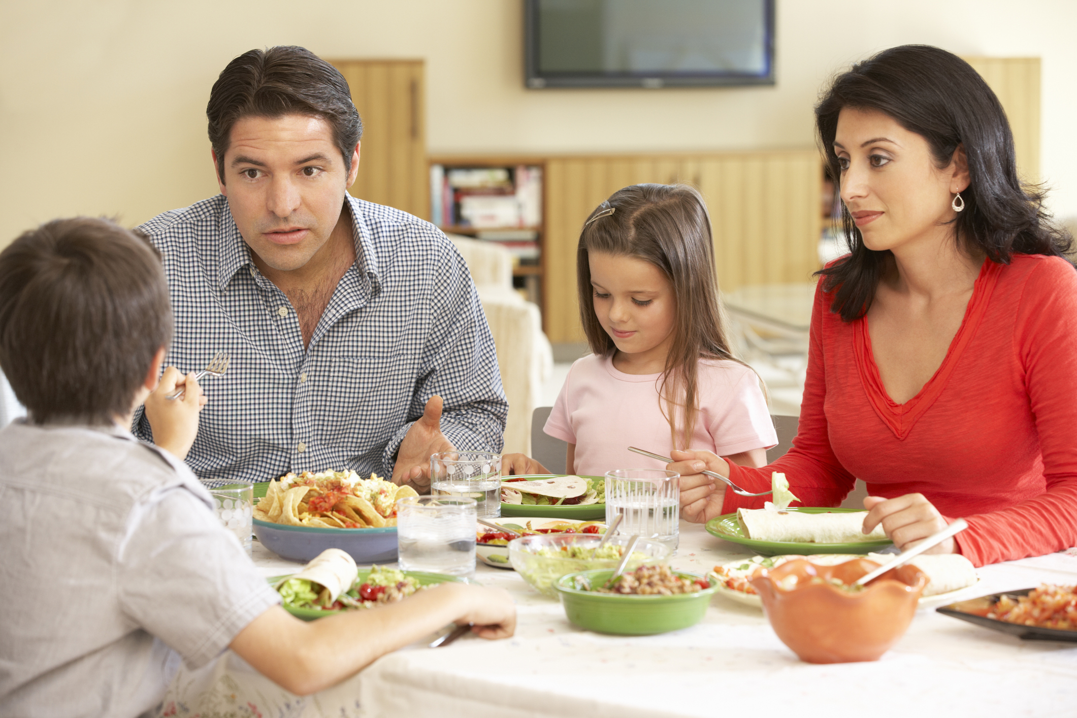 Young Hispanic Family Arguing While Having Meal