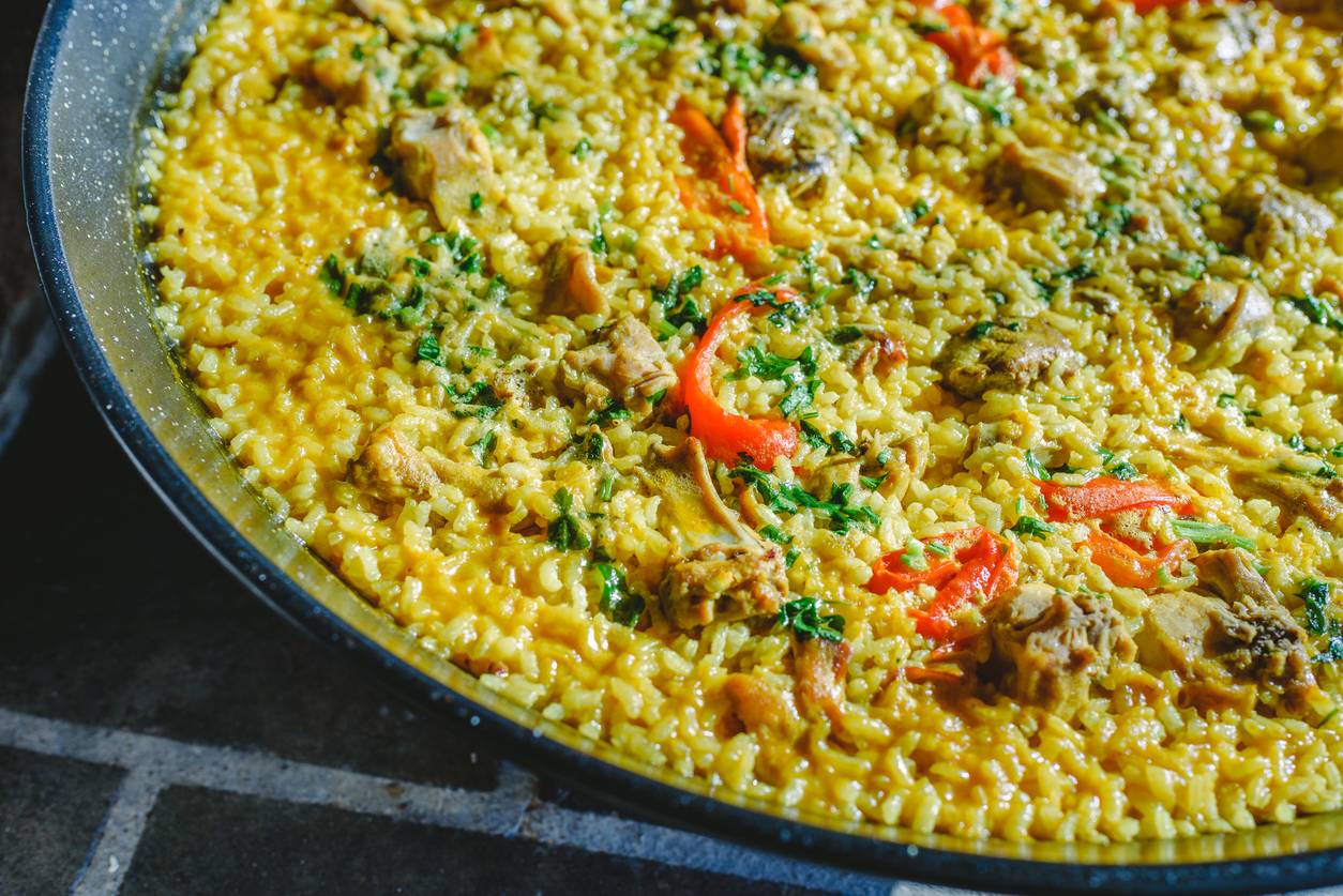 Rice and rabbit, typical dish of the gastronomy of the region of Murcia, Spain, cooked in a paella pan.