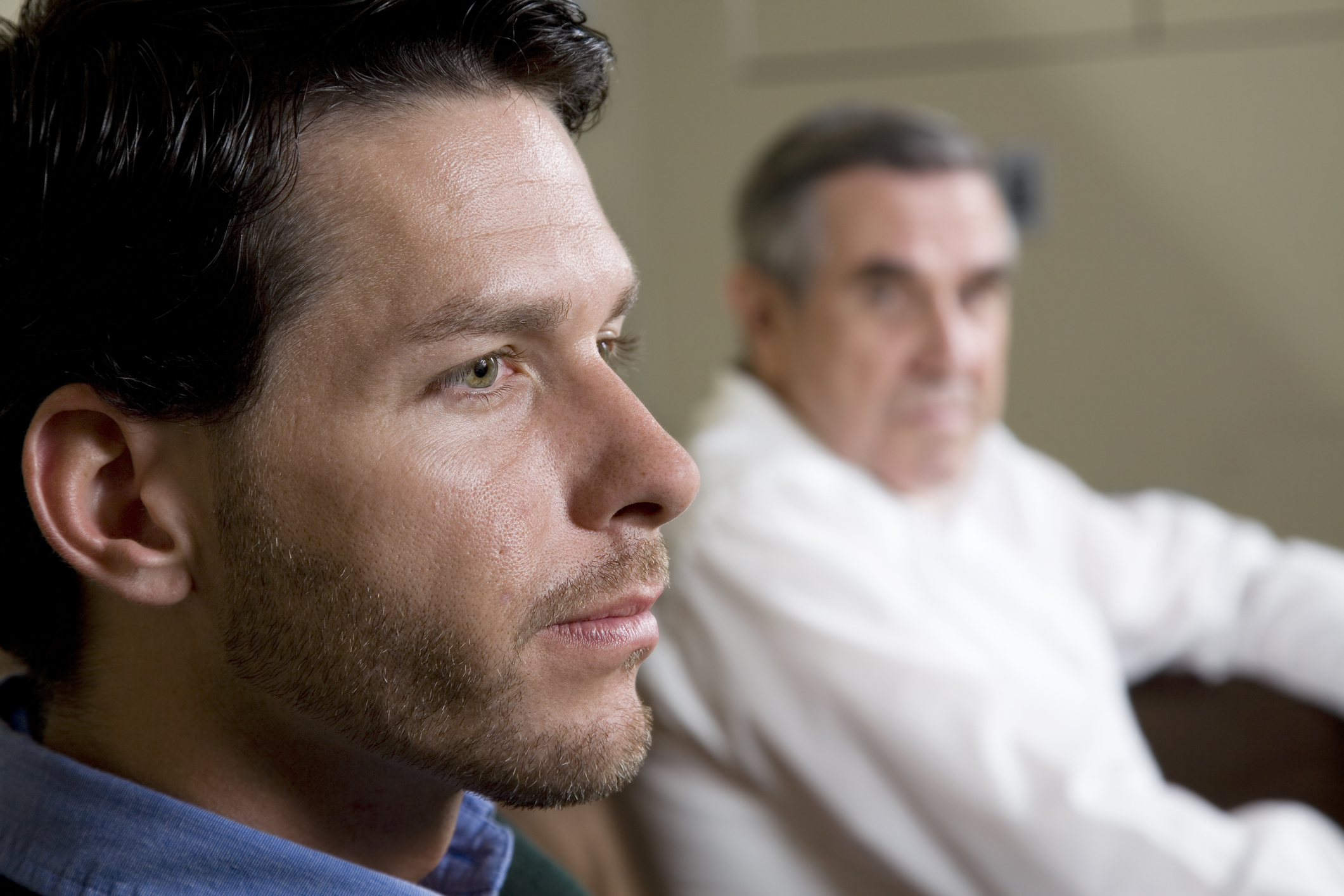 Closeup of man with father looking on