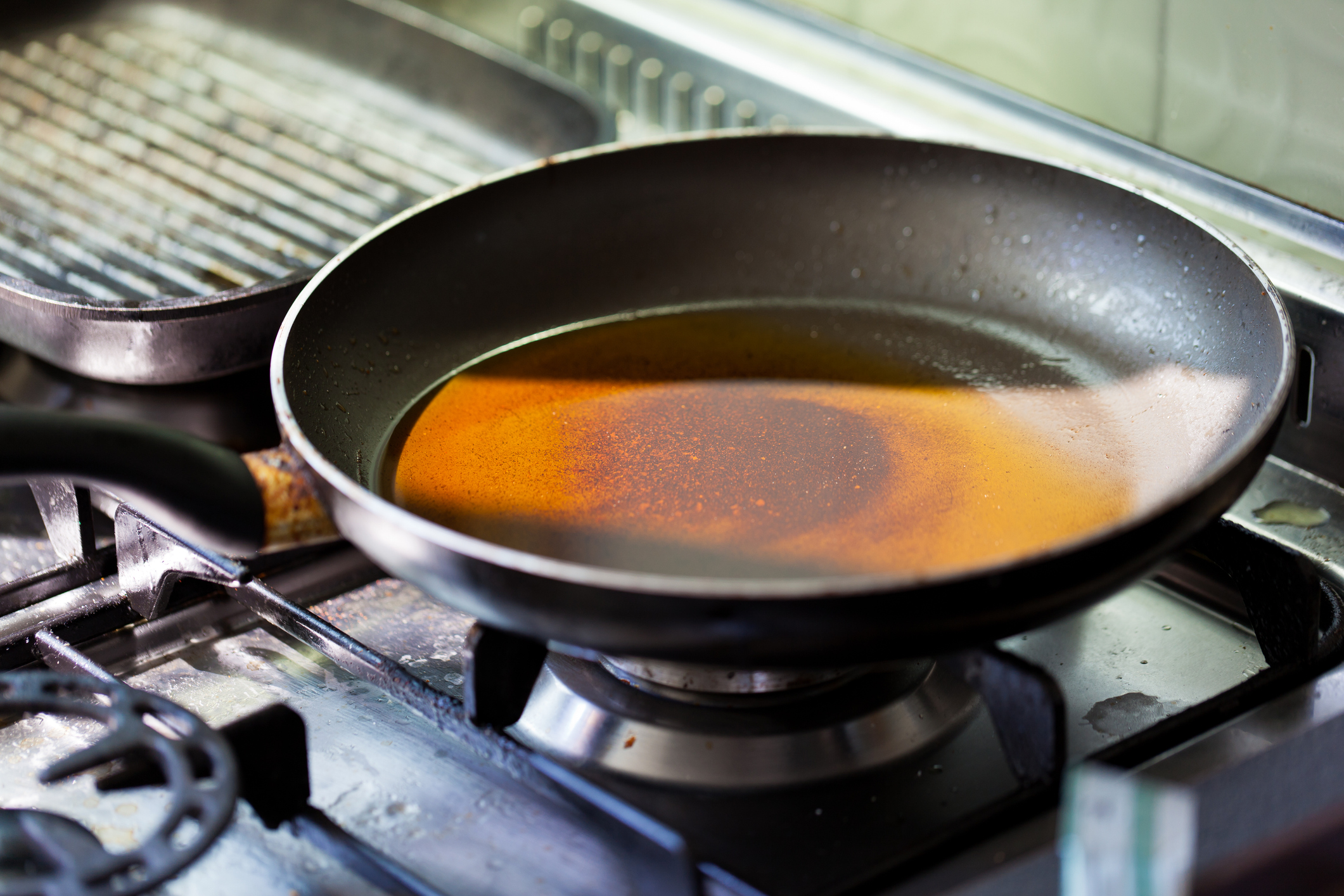 Dirty stove with a dirty frying pan