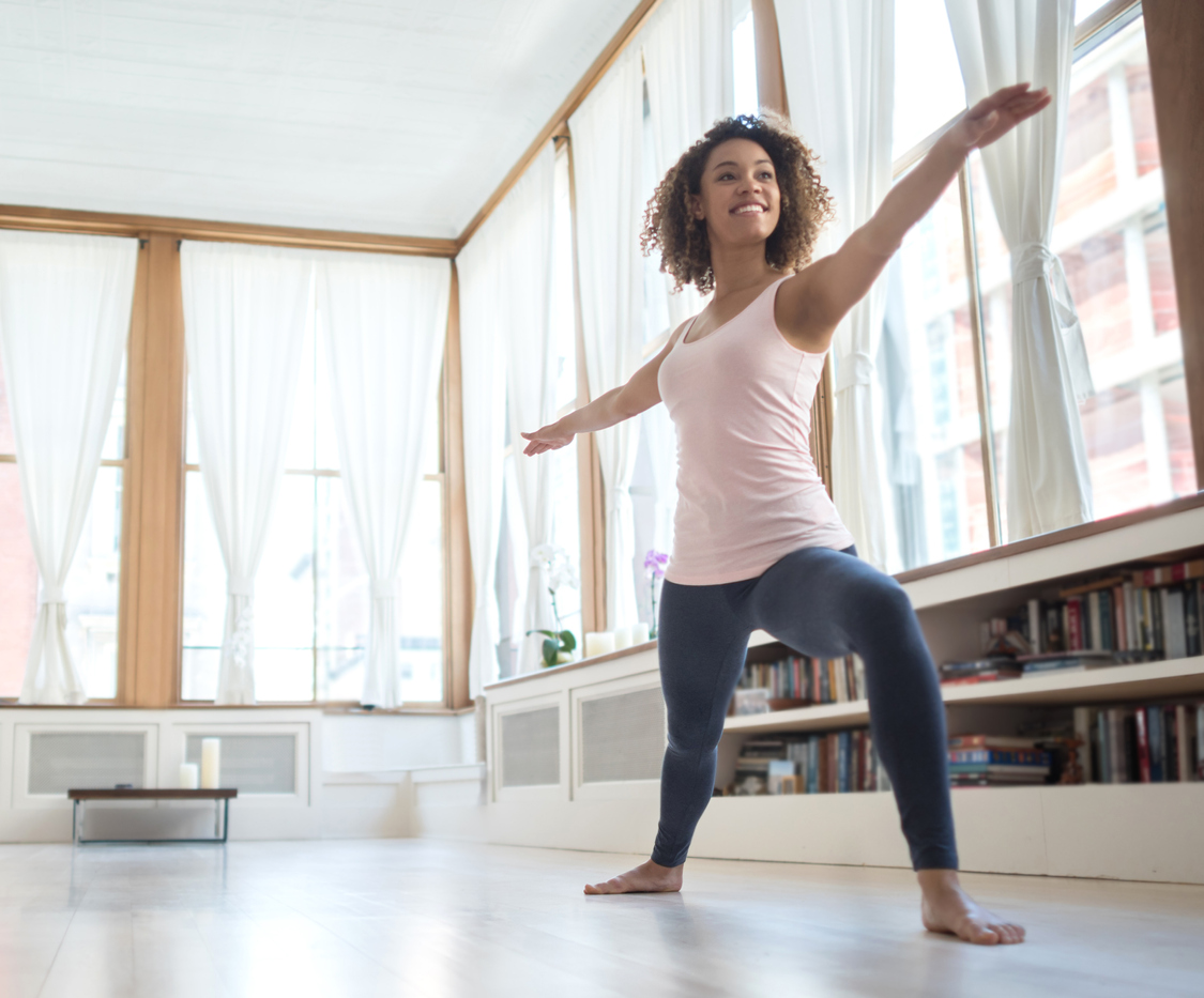 African American woman doing yoga at home